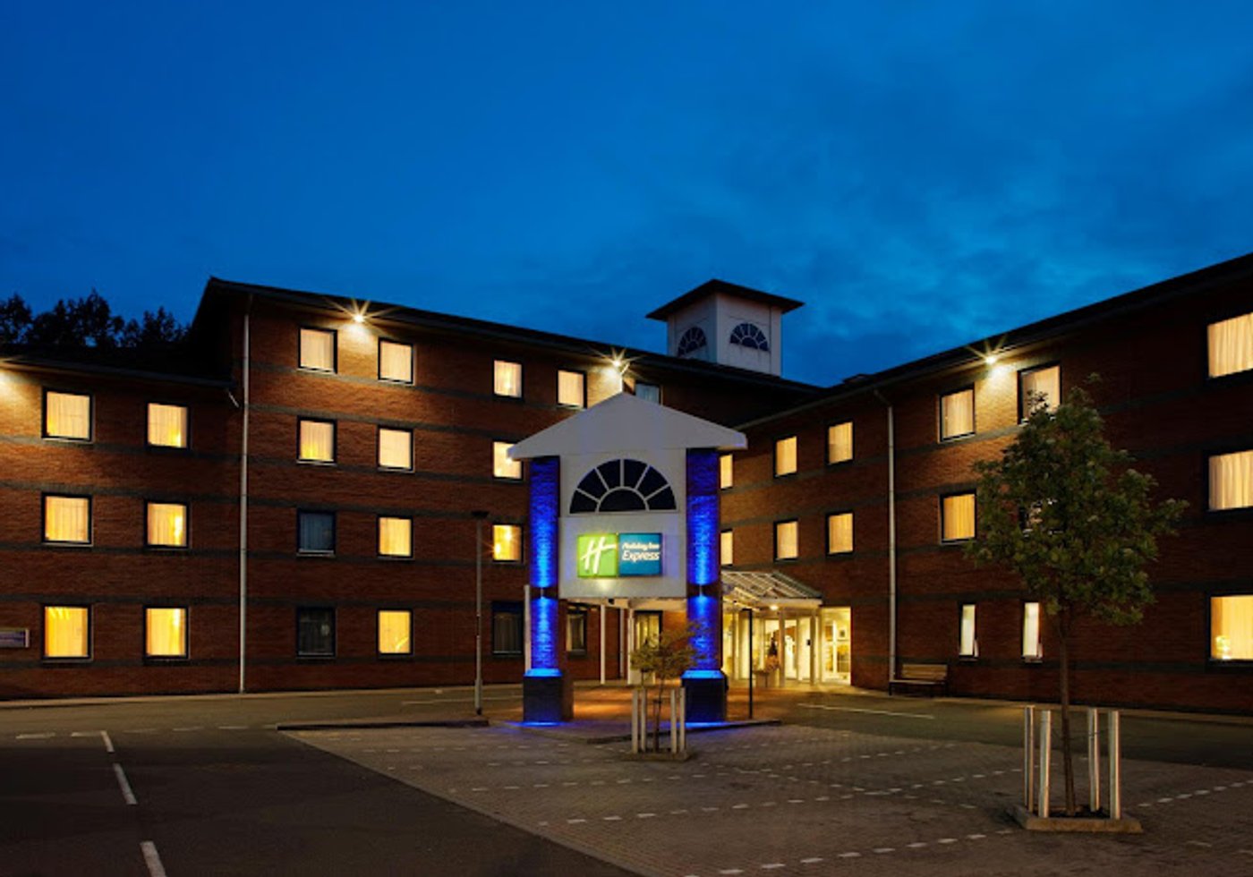 A charming hotel room in a historic building, with a view of the surrounding countryside and a comfortable bed with soft bedding